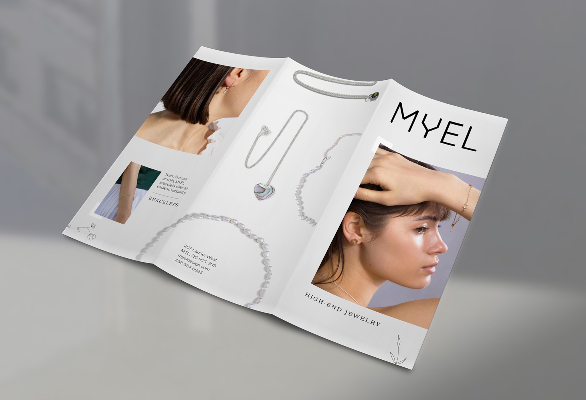 Outside view of the Myel Jewelry tri-fold brochure print I designed. This side displays the cover, several pieces of jewelry on their own, and some extra product shots and descriptions.